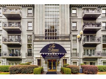 Exterior view of the The James at Buckhead featuring balconies, a large window, and neatly manicured landscaping at 3203 Lenox Ne Rd # 3, Atlanta, GA 30324