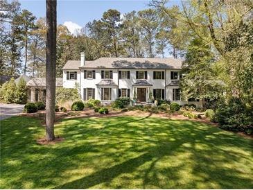 Stately home with a manicured lawn and mature landscaping; features a neutral color palette and classic design at 3540 Tuxedo Nw Rd, Atlanta, GA 30305