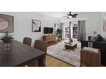 Inviting living room featuring a ceiling fan, neutral color palette and access to the balcony at 799 Hammond Dr # 205, Sandy Springs, GA 30328