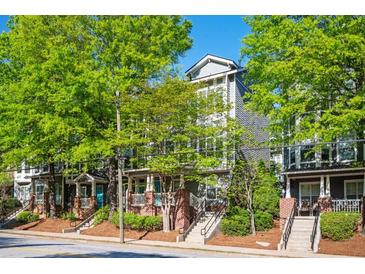 Charming townhomes with brick accents, stairs, and lush green trees at 1112 Park S Row, Atlanta, GA 30312