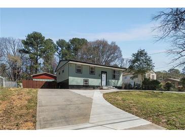Charming home with a long driveway and a well-maintained lawn at 6370 Boca Grande Blvd, Forest Park, GA 30297