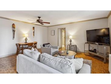 Cozy living room featuring parquet floors, stylish decor, and a comfortable seating area at 300 Peachtree Ne St # 18I, Atlanta, GA 30308