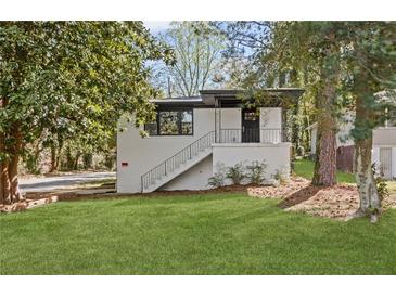 Charming renovated home featuring a white brick exterior and staircase leading to the front entrance at 175 Holly Nw Rd, Atlanta, GA 30314