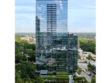 Modern high-rise building featuring glass facade and lush surrounding landscape at 3630 Peachtree Ne Rd # 2009, Atlanta, GA 30326