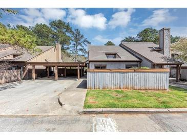 Charming home featuring a carport, chimney, and fenced yard at 109 Willowick Dr # 109, Lithonia, GA 30038