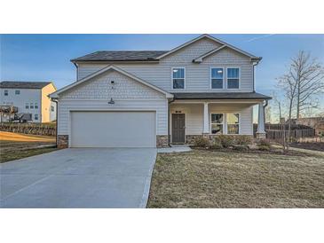 Charming two-story home with a two-car garage, covered entry, and manicured lawn at 123 Ledgemont Way, Acworth, GA 30101