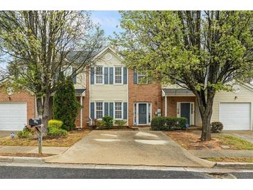 Charming townhouse with brick and siding, well-maintained landscaping, and inviting curb appeal at 345 Timber Gate Court, Lawrenceville, GA 30045