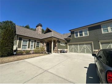 Beautiful, well-maintained home with a stone chimney, three-car garage and spacious driveway at 118 Cedarcrest Village Ct, Acworth, GA 30101