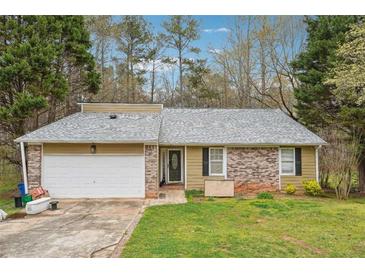 Charming one-story home featuring a brick facade and a spacious two-car garage at 845 James Path Ct, Lawrenceville, GA 30044
