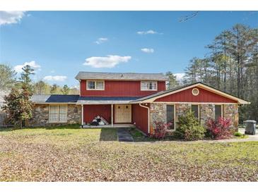 Charming two-story home with red siding and stone accents at 270 Oak Ridge Rd, Covington, GA 30016