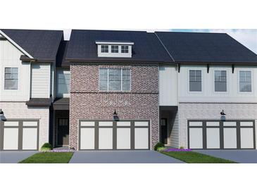 Charming brick and siding townhome with a two-car garage and a well-manicured lawn at 293 Depot Landing Rd, Auburn, GA 30011