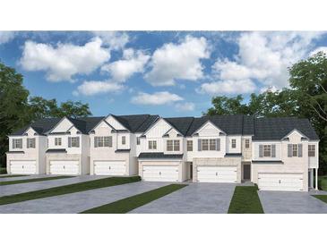 New townhomes showcasing a traditional design with white siding, brick accents, and private garages at 3058 Yellowhammer Dr, Marietta, GA 30064