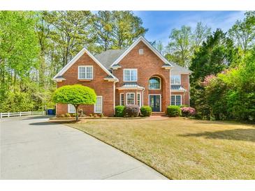 Traditional brick home with well-manicured lawn and mature landscaping, offering great curb appeal at 3816 Berrybridge Se Way, Marietta, GA 30067