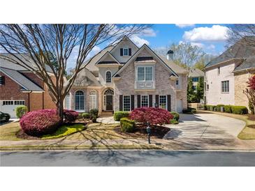 Charming two-story brick home with well-manicured lawn and beautiful landscaping in a desirable neighborhood at 12800 Wyngate Trl, Alpharetta, GA 30005