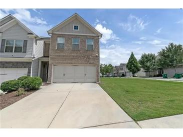 Attractive two-story home with a brick facade and a two-car garage at 3137 Spicy Cedar Ln, Stonecrest, GA 30038