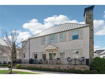 Charming home featuring shingle siding, metal roof, stone chimney, and inviting front porch at 204 N Esplanade, Alpharetta, GA 30009