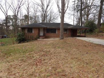 Charming single-story brick home featuring an open carport and front yard at 4269 Mercer Rd, Decatur, GA 30035