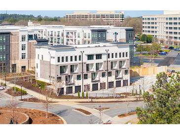 New townhome with attached garages, neutral colors and updated exterior design at 7110 Summit Pl, Alpharetta, GA 30009