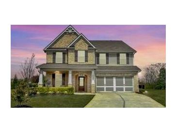 Inviting two-story home featuring brick and siding, attached garage and a manicured lawn at 526 Rosemont Ave, Canton, GA 30115
