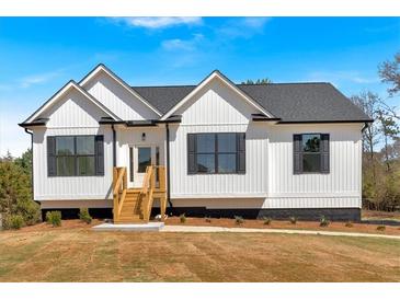 Charming exterior featuring white siding, dark shutters, and a well-manicured front yard at 81 Bridgemill Dr, Douglasville, GA 30134