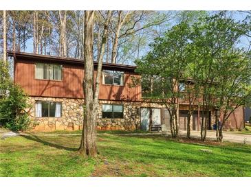 Charming split-level home with stone accents and a spacious two-car garage at 3100 Meadow Dr, Marietta, GA 30062