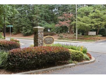 Well-maintained Dunwoody Court entrance with stone signage and manicured landscaping at 919 Dunbar Dr, Dunwoody, GA 30338