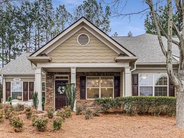 Charming single-story home with brick and tan siding, well-maintained landscaping, and inviting front porch at 1045 Brook Knoll Ln # 401, Cumming, GA 30041