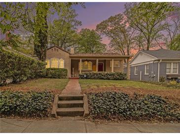 Charming bungalow with a brick walkway, front porch, and manicured landscaping at 650 Somerset Ne Ter, Atlanta, GA 30306