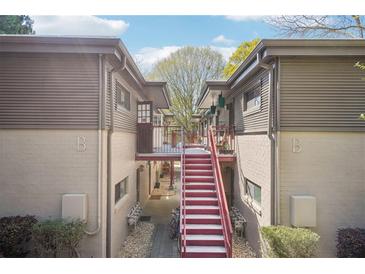 Exterior view of apartment complex featuring red stairs and exterior corridors at 1355 Euclid Ne Ave # B24, Atlanta, GA 30307
