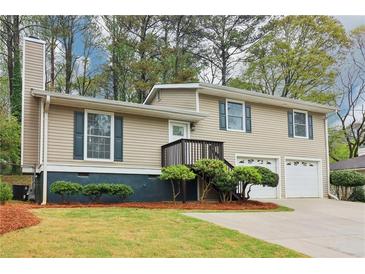 Inviting two-story home featuring a two-car garage, well-maintained lawn, and charming curb appeal at 746 Polk Nw St, Marietta, GA 30064