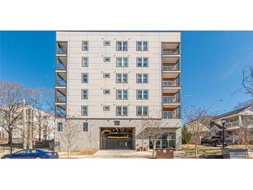 Modern condo building featuring multi-story living, balconies, and a covered parking garage at 525 Parkway Ne Dr # 103, Atlanta, GA 30308