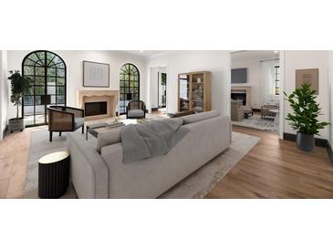 Bright living room with arched windows, fireplace, and hardwood floors creating an inviting atmosphere at 1 Mooregate Sq, Atlanta, GA 30327