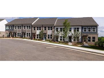 Newly constructed townhomes with brick and siding exteriors featuring multiple windows and professional landscaping at 335 Skylar Se Way, Atlanta, GA 30315