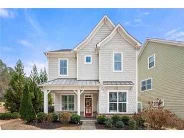 Charming two-story home with neutral siding, covered front porch, and well-maintained landscaping at 1977 Boyd Trace Nw Ln, Atlanta, GA 30318