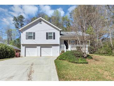 Charming two-story home featuring a two-car garage, front porch, and well-maintained landscaping at 5848 Dunn Sw Rd, Mableton, GA 30126