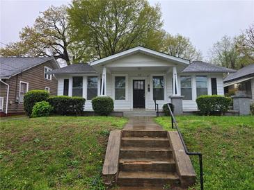 Charming single story home with a concrete staircase leading to a covered front porch entrance at 1012 Burns Dr, Atlanta, GA 30310