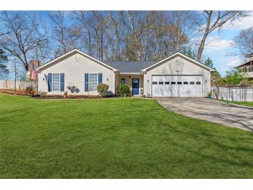 Charming single-story home with well-manicured lawn, two-car garage, and inviting curb appeal at 5720 Crow Dr, Cumming, GA 30041