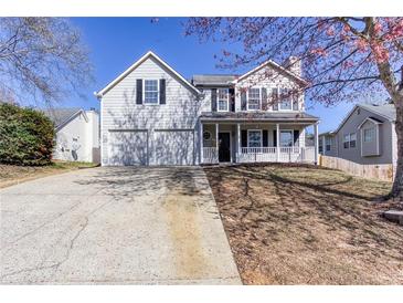 Charming two-story home with a welcoming front porch, two-car garage, and well-maintained lawn at 4502 Lake Park Dr, Acworth, GA 30101