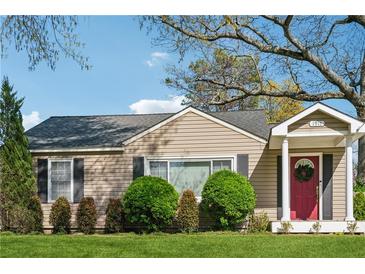 Charming single-story home featuring a red front door, well-maintained landscaping, and classic architectural details at 1911 Woodland Hills Nw Ave, Atlanta, GA 30318