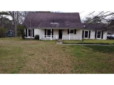 Charming single-story home featuring a cozy front porch and a traditional, well-maintained lawn at 2326 Noahs Ark Rd, Jonesboro, GA 30236