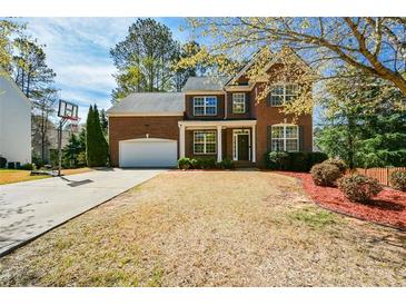 Charming two-story brick home with a well-manicured lawn and attached garage at 6065 Nw Gentlewind Court Nw Ct, Powder Springs, GA 30127