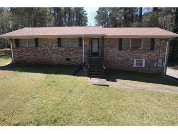 Traditional brick home with a well-manicured lawn, a inviting entrance with steps, and plenty of natural light at 5159 Covington Hwy, Decatur, GA 30035