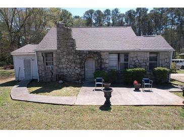 Charming stone-clad home with a cozy front patio and a well-maintained front yard at 5181 Covington Hwy, Decatur, GA 30035