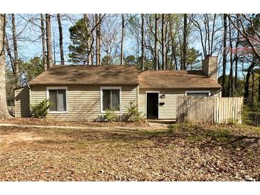Charming single-story home featuring neutral siding and a well-maintained front yard at 5050 Martins Crossing Rd, Stone Mountain, GA 30088