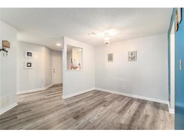 Bright dining room featuring wood-look floors and nautical-themed decorations, adjacent to the front door at 813 Ridgefield Dr, Peachtree City, GA 30269