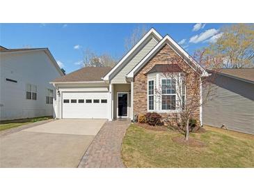 Charming single-story home featuring stone accents, a well-manicured lawn, and a two-car garage at 2130 Birkdale St, Villa Rica, GA 30180
