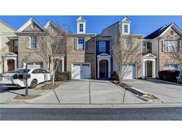 Charming brick townhome with manicured landscaping and attached one car garage at 1749 Coleville Oak Ln, Lawrenceville, GA 30046