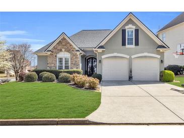 Charming home featuring stone accents, manicured landscaping, and a two-car garage at 2250 Snug Ne Hbr, Marietta, GA 30066