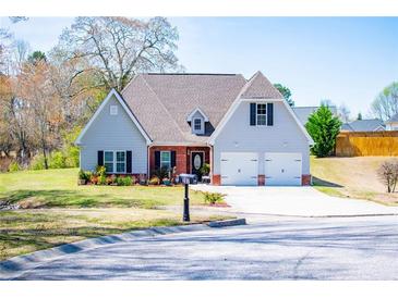 Charming two-story home with a well-manicured lawn and attached two-car garage at 207 Meadow Lake Dr, Carrollton, GA 30116