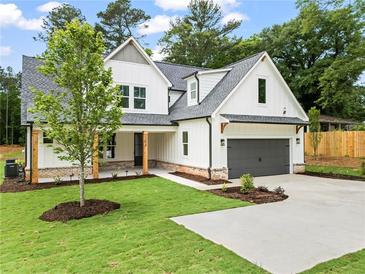 Charming new construction with a modern farmhouse design and well-manicured lawn at 1698 Cunningham Sw Rd, Marietta, GA 30008